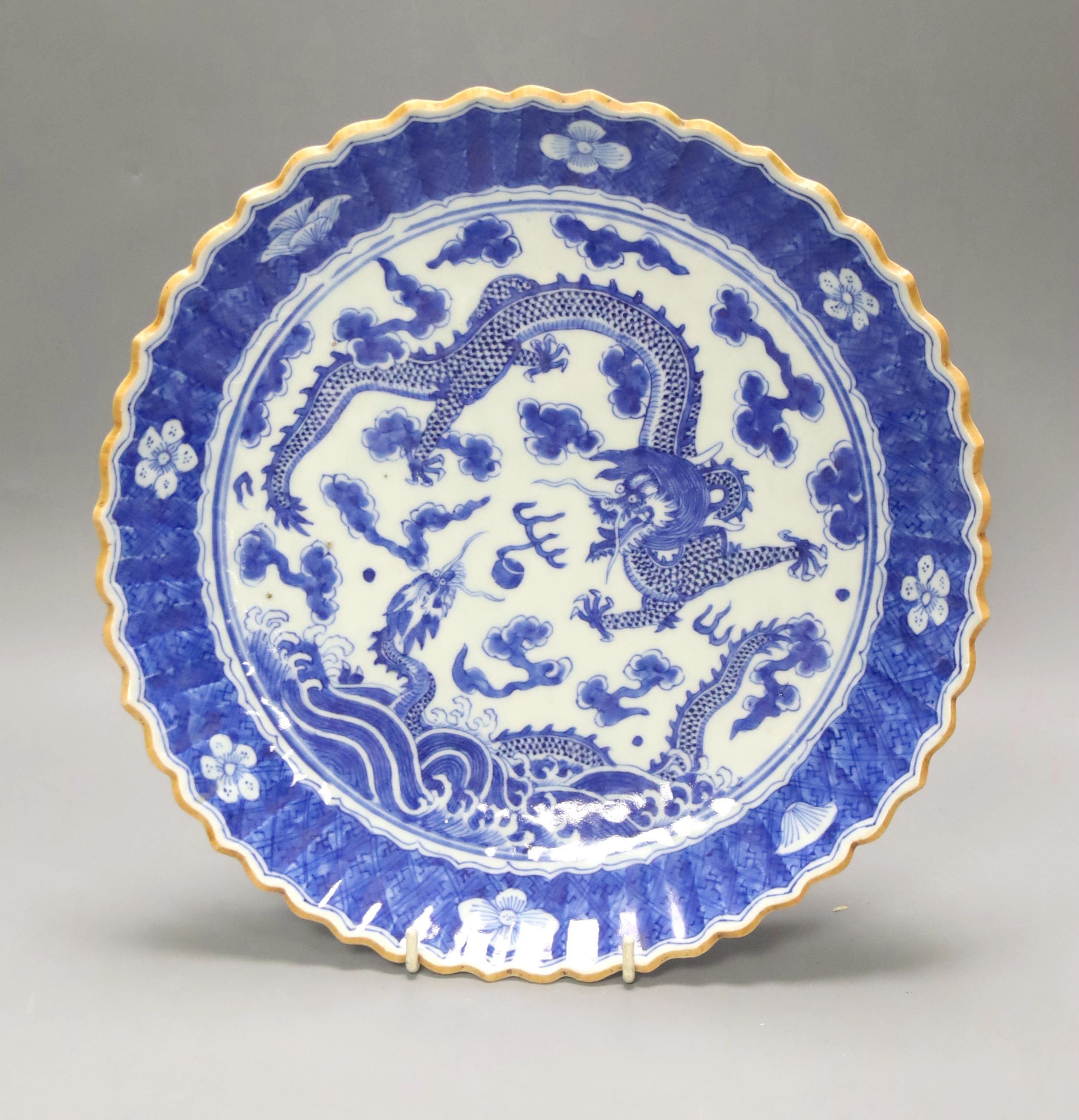 A Chinese blue and white dragon dish, 19th century with a Chenghua mark, 29cm